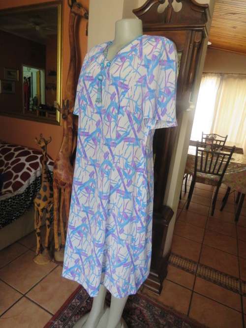 Cool owner made white polyester princess style dress with lilac/blue graphic print.Size 40/16.As new