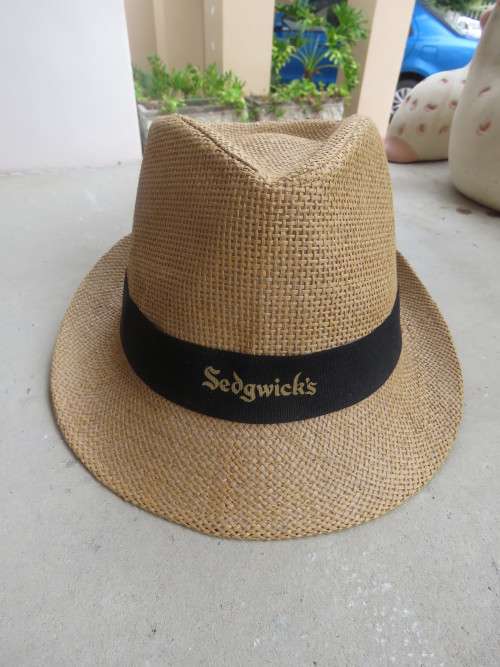 Men`s paper rattan fedora style hat size 58cm. Black band with SEDGWICK`S logo.New condition