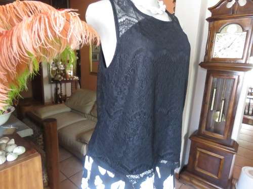 Go feminine with this sleeveless black acrylic lace slip over top.Underlay in stretch poly.Size 36