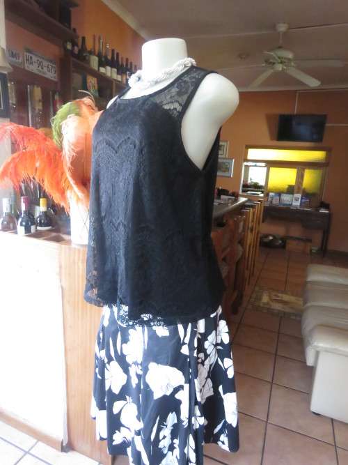 Go feminine with this sleeveless black acrylic lace slip over top.Underlay in stretch poly.Size 36
