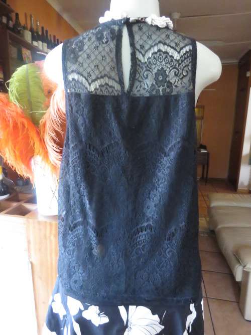 Go feminine with this sleeveless black acrylic lace slip over top.Underlay in stretch poly.Size 36