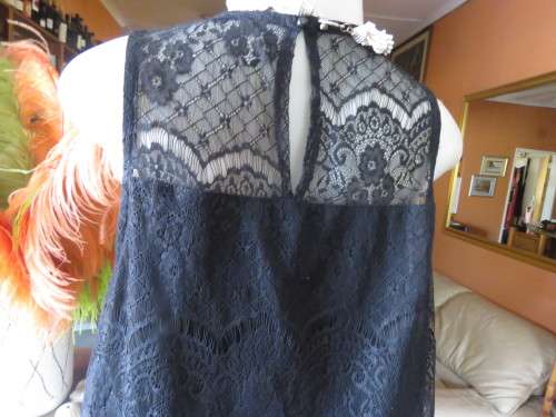 Go feminine with this sleeveless black acrylic lace slip over top.Underlay in stretch poly.Size 36