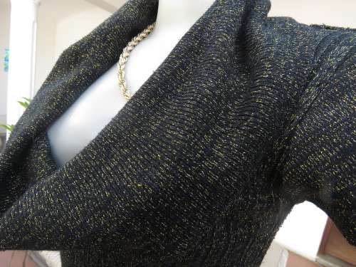 All that glitters!! Black acrylic knitted capped sleeve top with gold thread.Amazing collar.Size 38