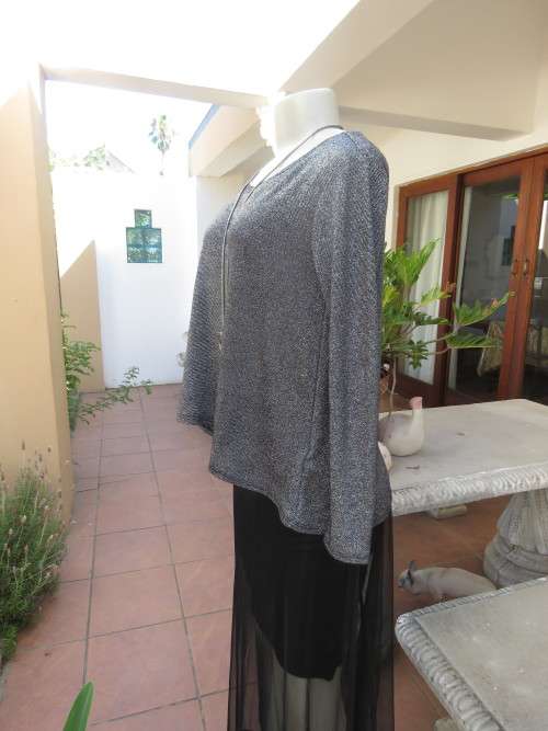 Glitter long sleeve slip over top in polyester,viscose,metalic silver.Size 36 to 38 by H+M As new