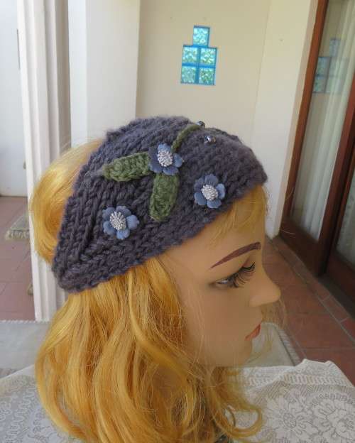 Chic bluegrey knitted hairband 12cm wide with knitted flower and green leaves on sides.As new.