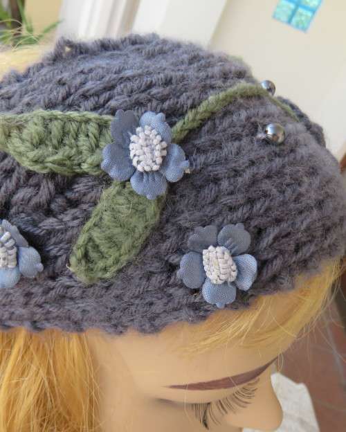 Chic bluegrey knitted hairband 12cm wide with knitted flower and green leaves on sides.As new.