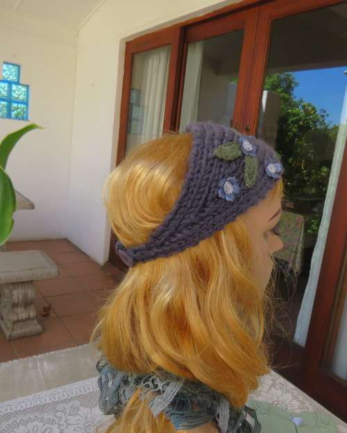 Chic bluegrey knitted hairband 12cm wide with knitted flower and green leaves on sides.As new.