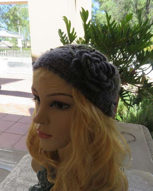 Chic bluegrey knitted hairband 12cm wide with knitted flower and green leaves on sides.As new.