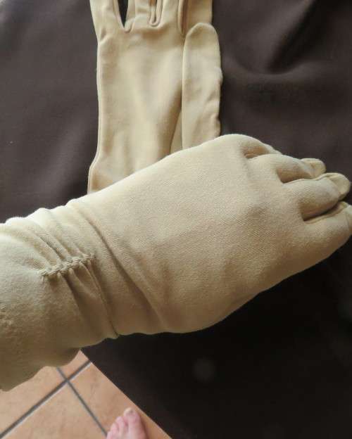 Pair of vintage wheat colour ladies gloves in size 7.5 with decoration on wrist. Good condition.