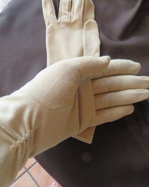 Pair of vintage wheat colour ladies gloves in size 7.5 with decoration on wrist. Good condition.