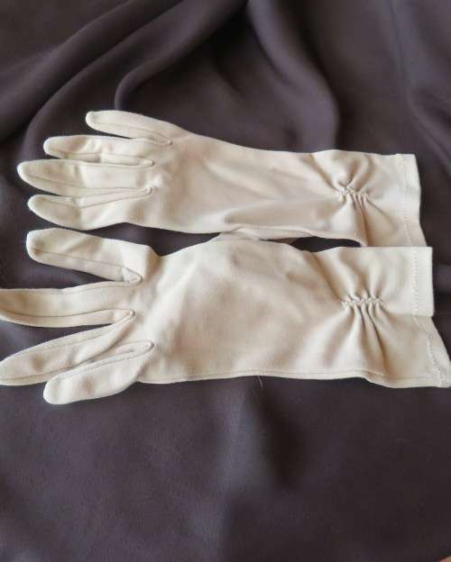 Pair of vintage wheat colour ladies gloves in size 7.5 with decoration on wrist. Good condition.
