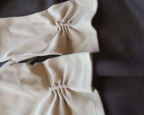 Pair of vintage wheat colour ladies gloves in size 7.5 with decoration on wrist. Good condition.