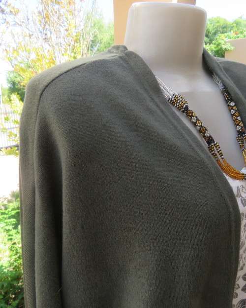 Knitted shrug in dark olive green polyester stretch knit.Size 42/18 by AMARA.Bolero front.As new.
