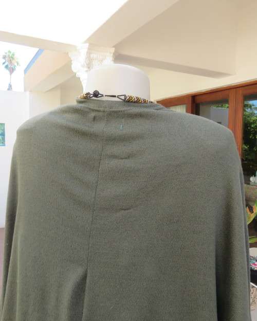 Knitted shrug in dark olive green polyester stretch knit.Size 42/18 by AMARA.Bolero front.As new.