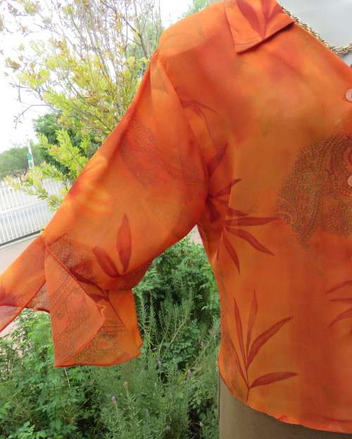 Bright orange/brick colour patterned button down top with collar by ZOEY size 36/12.Flare cuffs.