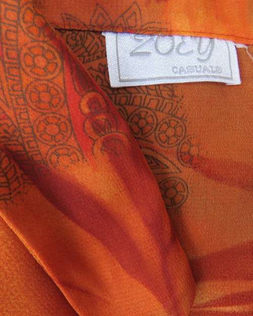Bright orange/brick colour patterned button down top with collar by ZOEY size 36/12.Flare cuffs.
