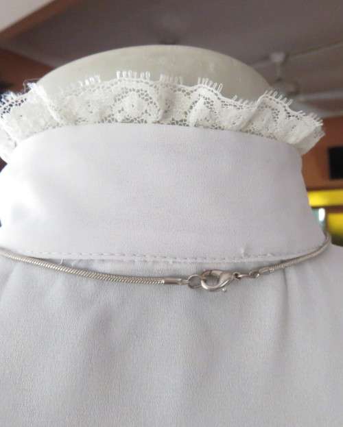 Stylish 80`s long sleeve button down light grey blouse with high banded collar.Size 32 by FOSHINI.