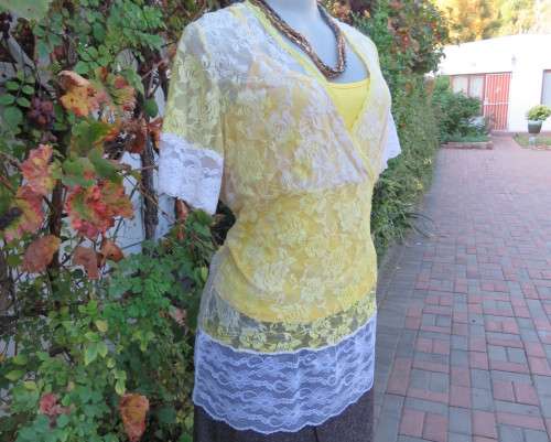 Adorable acrylic lace long empire cross over top in yellow and cream with strappy top.Size 38/14.