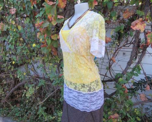 Adorable acrylic lace long empire cross over top in yellow and cream with strappy top.Size 38/14.