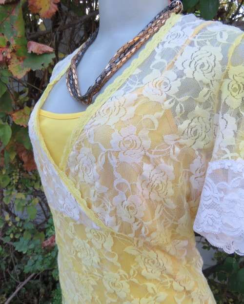 Adorable acrylic lace long empire cross over top in yellow and cream with strappy top.Size 38/14.