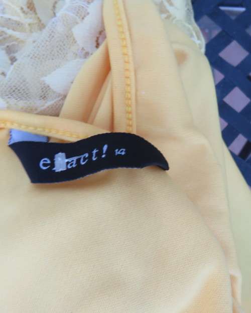 Adorable acrylic lace long empire cross over top in yellow and cream with strappy top.Size 38/14.