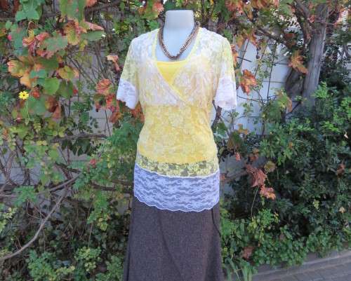 Adorable acrylic lace long empire cross over top in yellow and cream with strappy top.Size 38/14.
