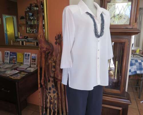Classic white button down blouse with open collar and elbow length sleeves.Size 40/16.WOOLWORTHS