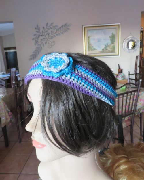 Pretty crochet acrylic hairband in purple/grey/blue stripes with flower.Purple braiding ties at back
