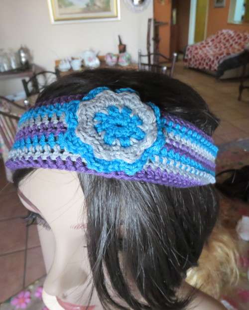 Pretty crochet acrylic hairband in purple/grey/blue stripes with flower.Purple braiding ties at back
