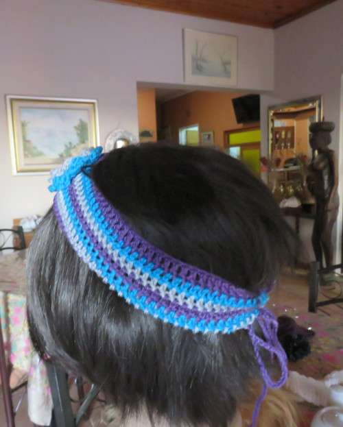 Pretty crochet acrylic hairband in purple/grey/blue stripes with flower.Purple braiding ties at back