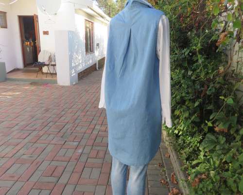 Versatile light blue denim 100% cotton long loose top with hidden button down.Size 38/14.