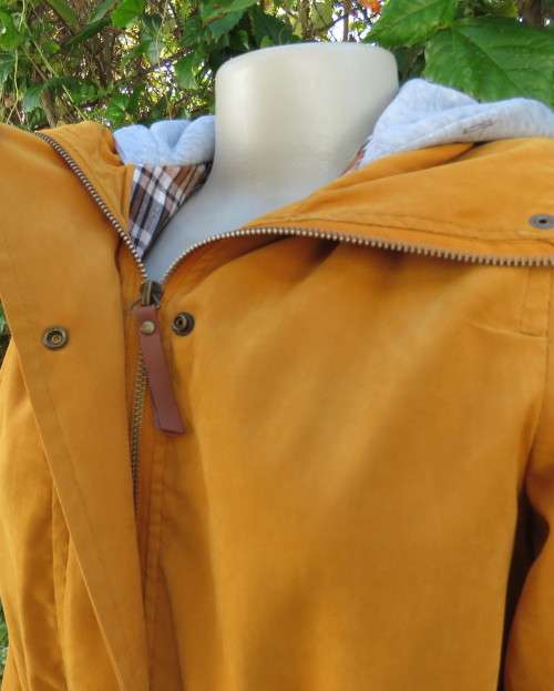 Fashion long sleeve jacket in mustard yellow.Grey hood.Drawstring in waist.Check lining.Size 34/10