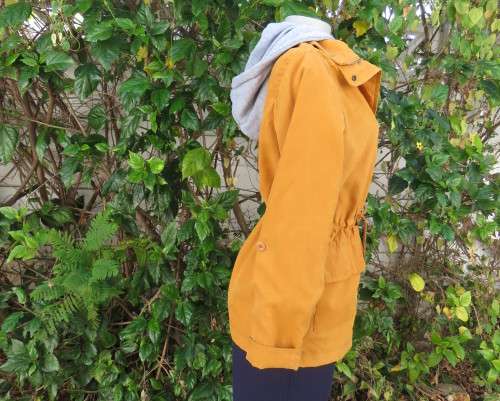 Fashion long sleeve jacket in mustard yellow.Grey hood.Drawstring in waist.Check lining.Size 34/10