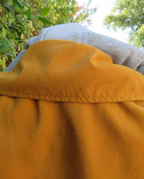 Fashion long sleeve jacket in mustard yellow.Grey hood.Drawstring in waist.Check lining.Size 34/10