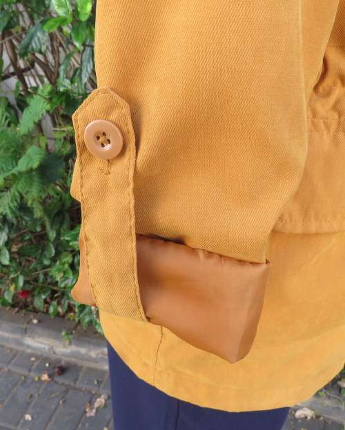 Fashion long sleeve jacket in mustard yellow.Grey hood.Drawstring in waist.Check lining.Size 34/10