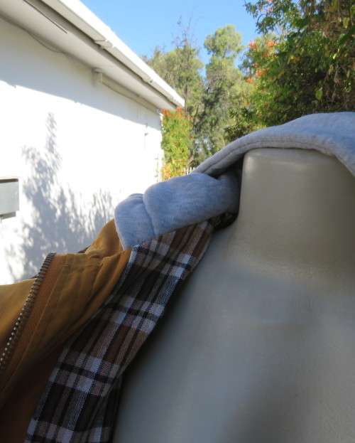 Fashion long sleeve jacket in mustard yellow.Grey hood.Drawstring in waist.Check lining.Size 34/10