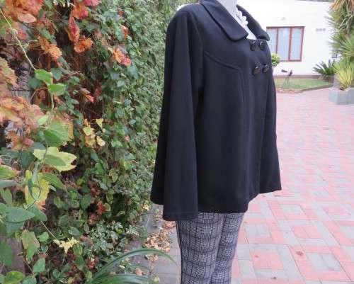 Stunning warm black swing fully lined double breast jacket with rounded collar.Size 48/24 by DONNA-C