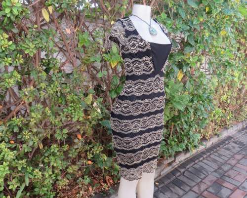 Stunning sexy evening bodycon in black stretch polyester with black/gold lace.Size 32 As new.