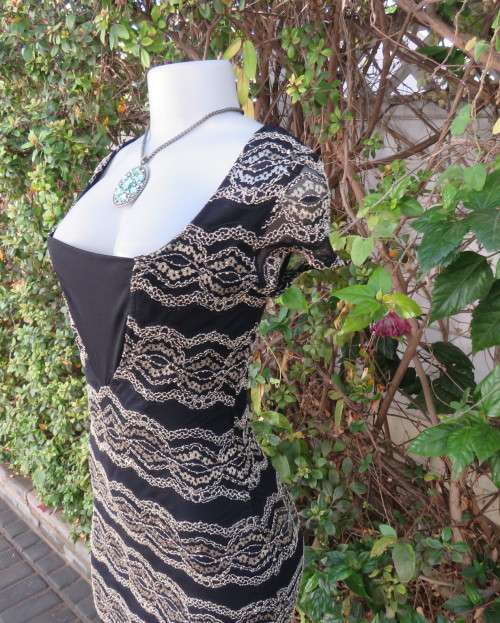 Stunning sexy evening bodycon in black stretch polyester with black/gold lace.Size 32 As new.