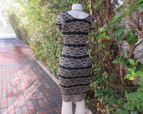 Stunning sexy evening bodycon in black stretch polyester with black/gold lace.Size 32 As new.