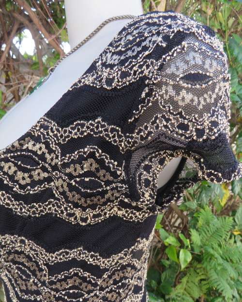 Stunning sexy evening bodycon in black stretch polyester with black/gold lace.Size 32 As new.