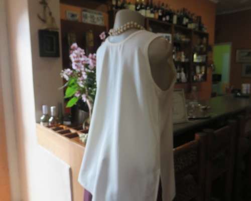 Cream cami style slip over silky polyester top by CONTRADICT size 36/12. Slits at sides.Scooped neck
