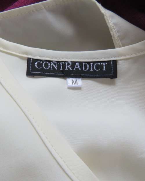 Cream cami style slip over silky polyester top by CONTRADICT size 36/12. Slits at sides.Scooped neck