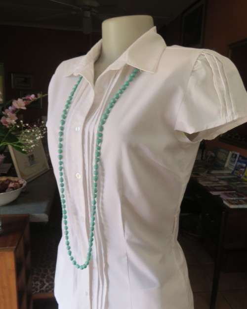 Charming white button down tailored top with tucked seams on front and capped sleeves.Size 34