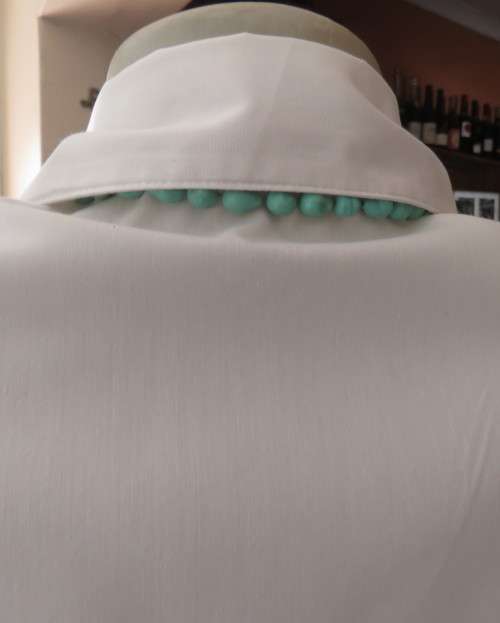 Charming white button down tailored top with tucked seams on front and capped sleeves.Size 34