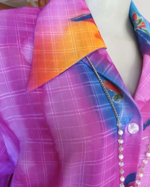 Amazing 2 pc pant suit with violet pants and violet,orange,jade pattened glitter top.Size 42/18.