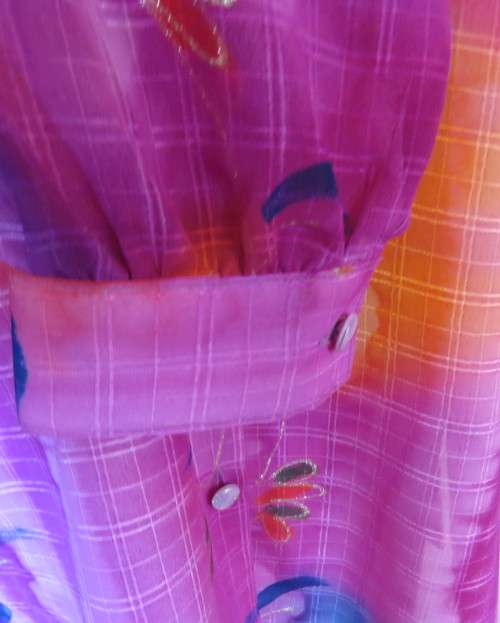 Amazing 2 pc pant suit with violet pants and violet,orange,jade pattened glitter top.Size 42/18.
