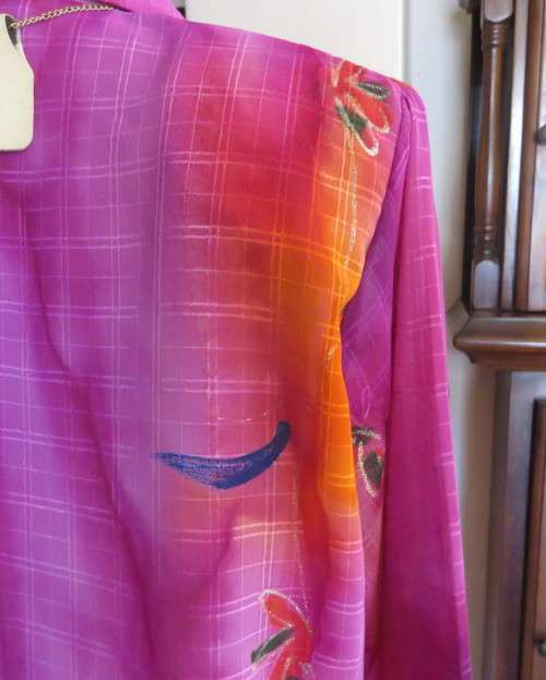 Amazing 2 pc pant suit with violet pants and violet,orange,jade pattened glitter top.Size 42/18.