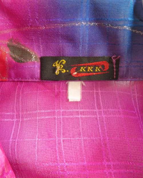 Amazing 2 pc pant suit with violet pants and violet,orange,jade pattened glitter top.Size 42/18.
