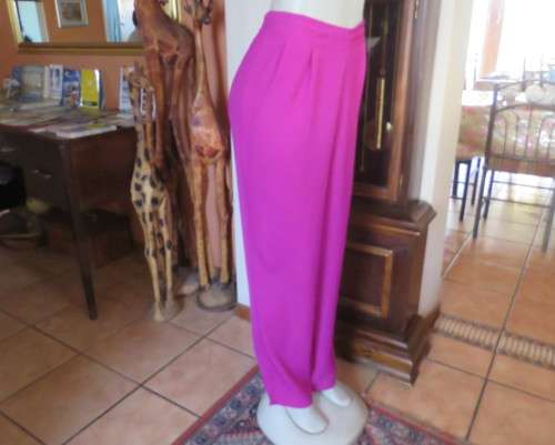 Amazing 2 pc pant suit with violet pants and violet,orange,jade pattened glitter top.Size 42/18.